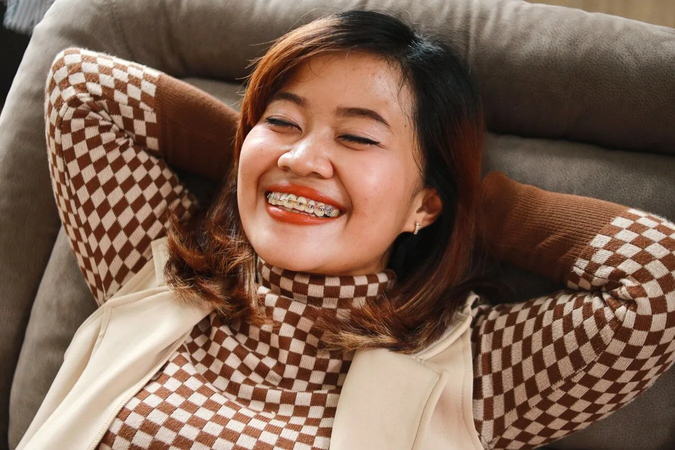 Smiling adult woman wearing braces