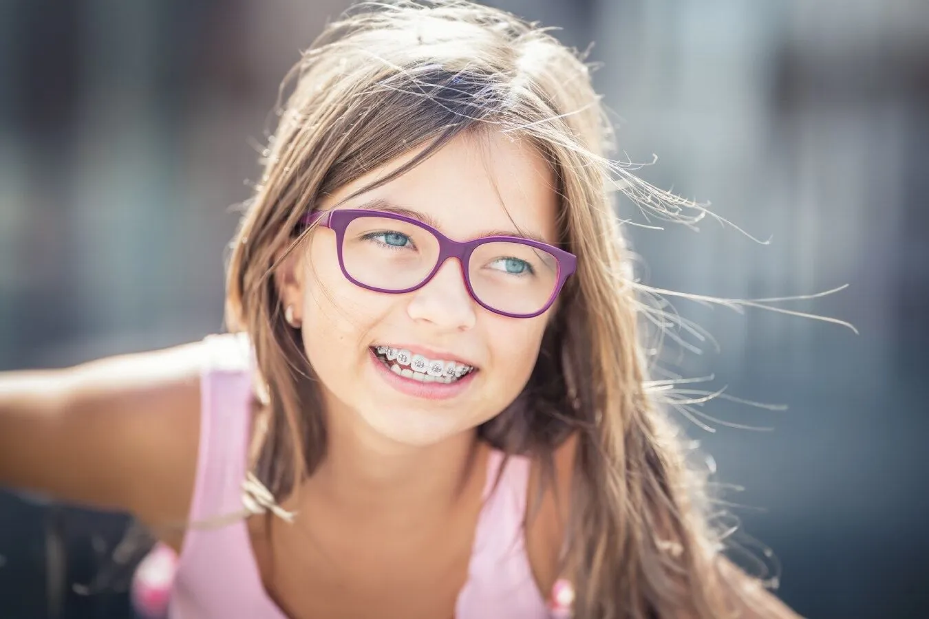 Smiling girl with glasses wearing braces