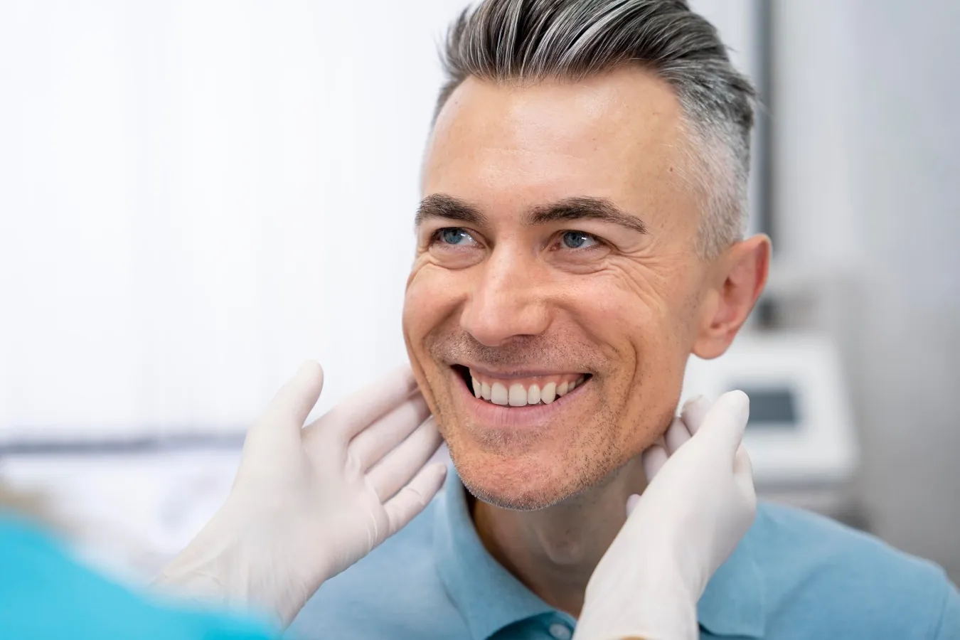 Smiling man having his jaw examined